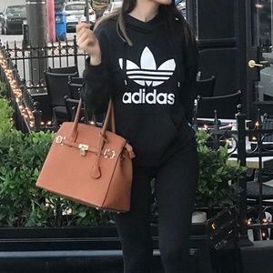 BROWN/ORANGY BAG WITH GOLD LOCKER